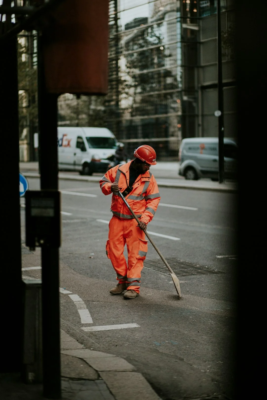 A man cleaning skyscraper windows with a harness, showcasing urban high-rise work.